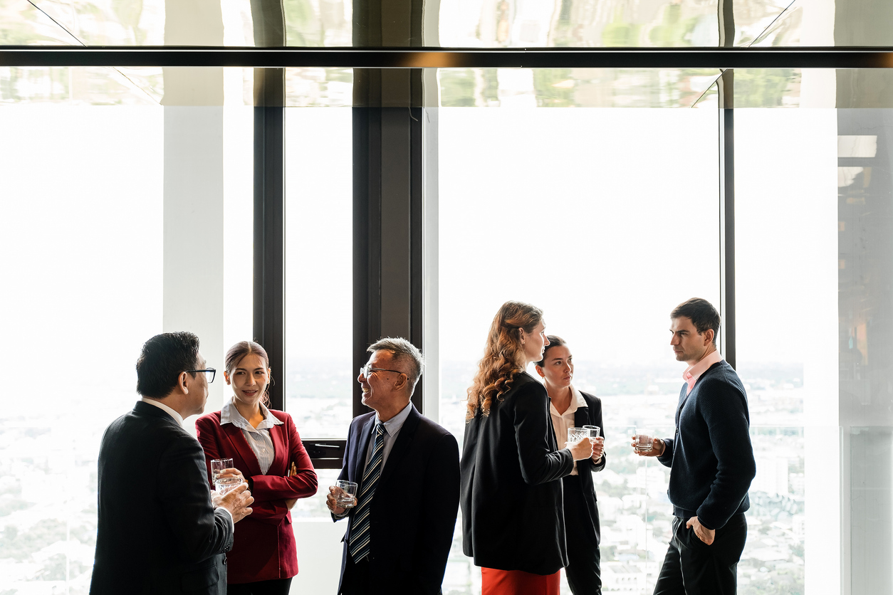 Business professionals networking in a modern high-rise with panoramic city views