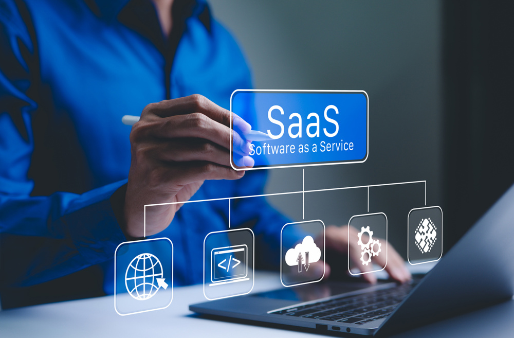 SaaS Concept, Software as a Service, A person interacts with a digital interface SaaS (Software as a Service) and various cloud-based icons, represent software management and cloud computing services