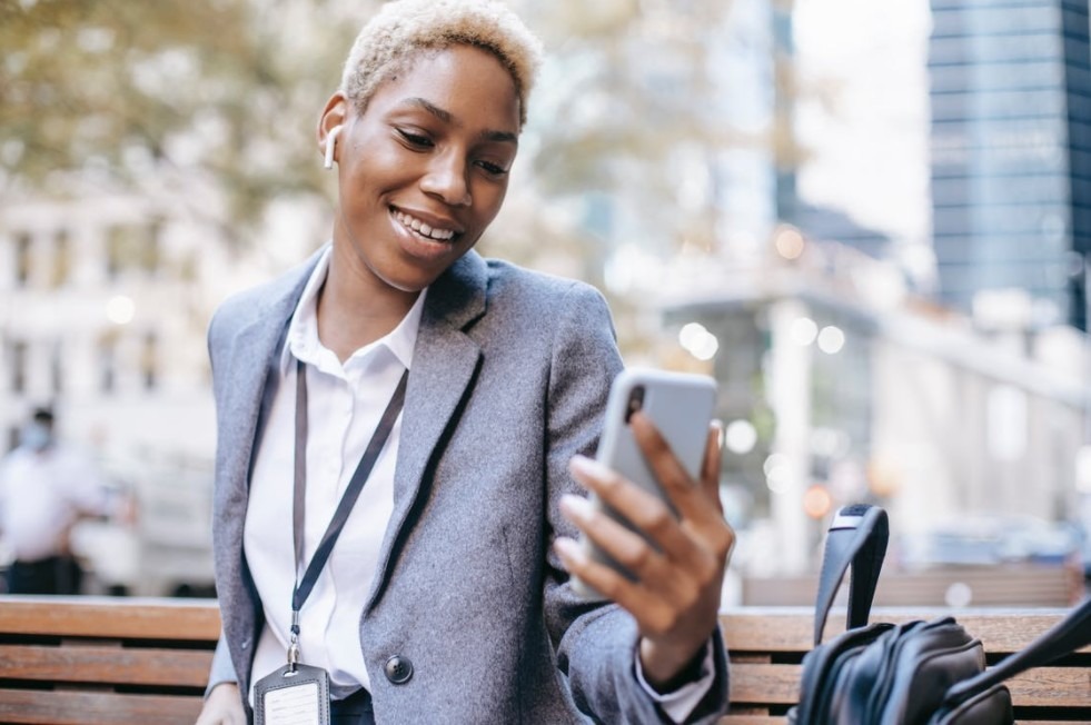 content-young-ethnic-female-entrepreneur-having-video-call-on-city-street