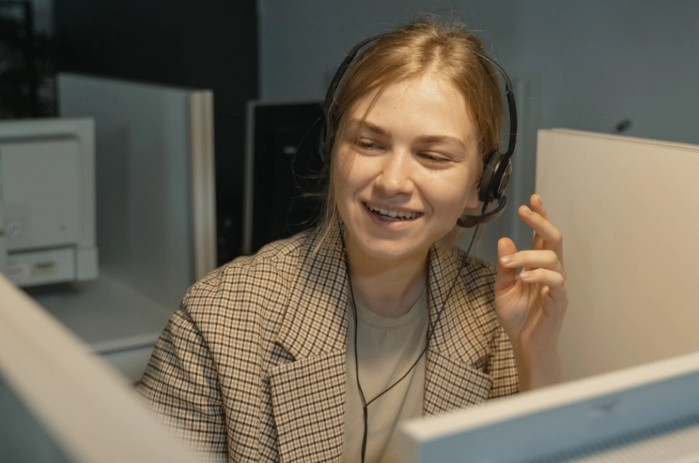 woman-in-brown-and-white-plaid-blazer-wearing-black-headphones