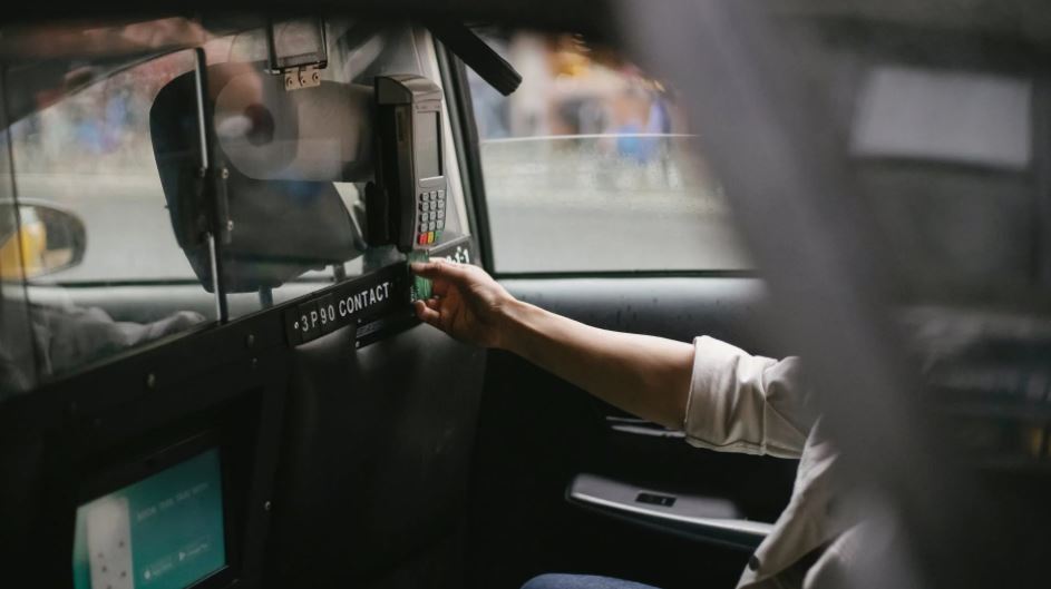 A passenger inserting the card in a taxi