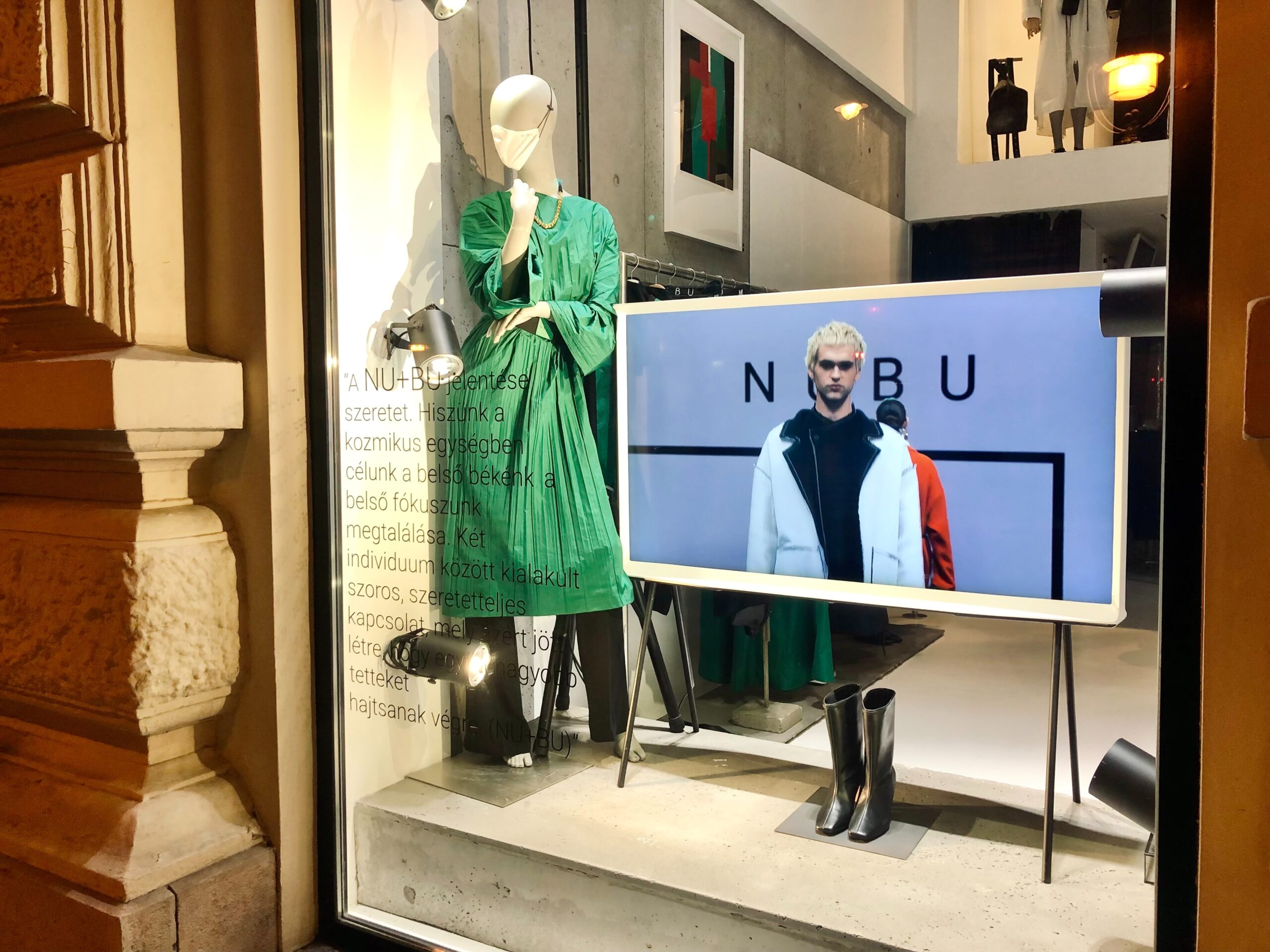 -window-display-with-mannequins-dressed-in-green-and-black